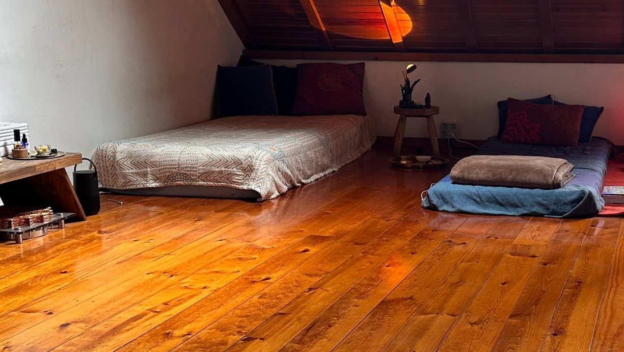 Mattresses in the Lisbon room in warm lamp light